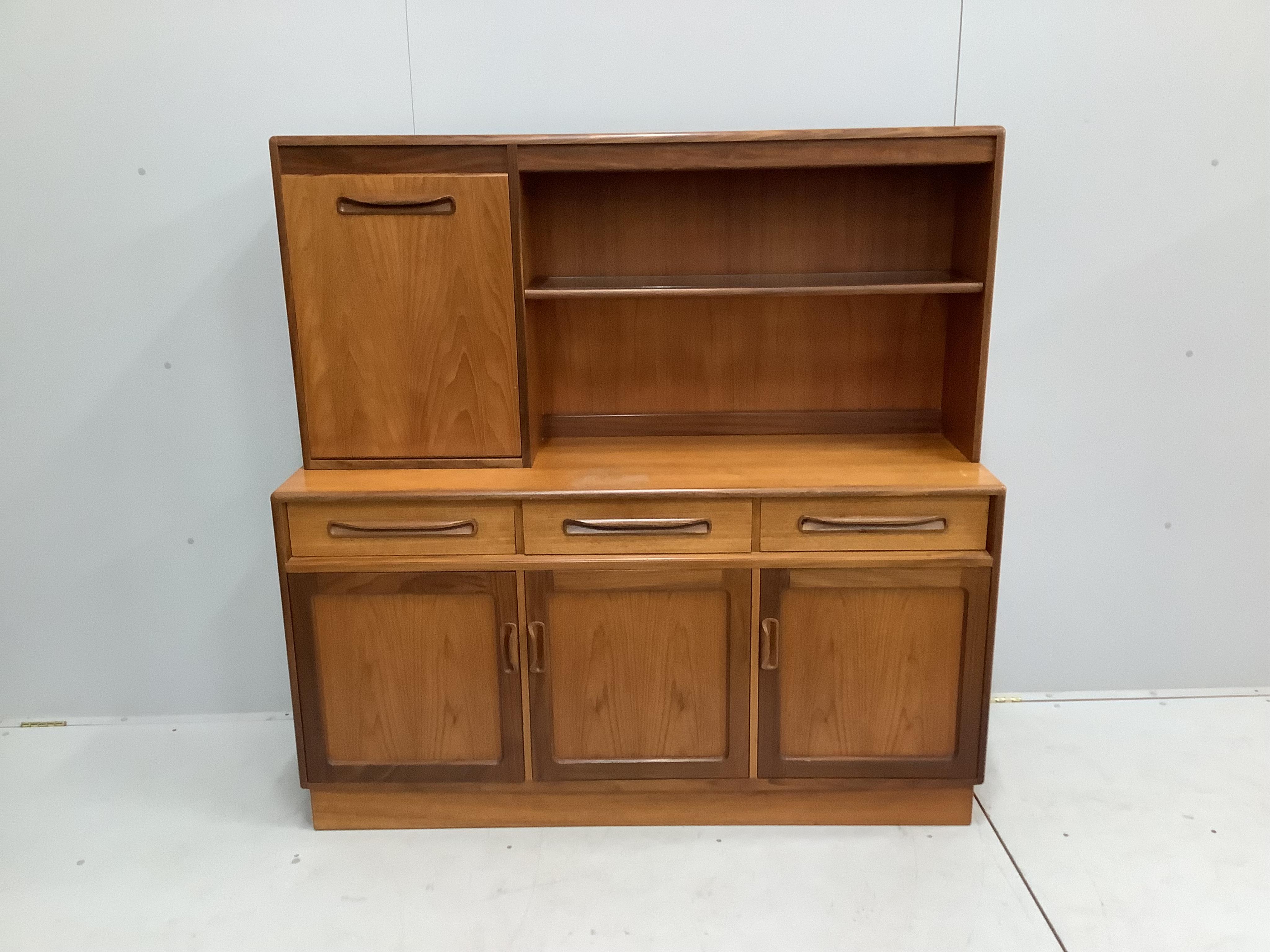 A mid century G Plan teak sideboard, width 142cm, depth 44cm, height 140cm. Condition - fair